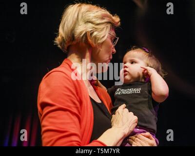 Cedar Rapids, Iowa, USA. 25th Apr, 2019. US Sen. ELIZABETH WARREN (D MA) holds a baby wearing a tee shirt that says ''Nevertheless she persisted'' after Warren's campaign speech at the Linn Phoenix Club in Cedar Rapids. Warren's supporters adapted ''Nevertheless she persisted'' as their own after Mitch McConnell said it to Warren as an insult. The Linn Phoenix Club is an organization that promotes Democratic candidates in Linn County, Iowa. Sen. Warren is campaigning in eastern Iowa Thursday night and Friday to promote her bid to the Democratic candidate for the US Presidency. Iowa tradition Stock Photo
