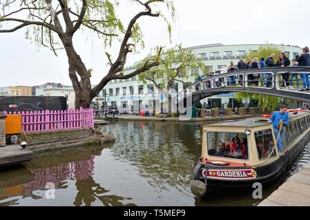 The Regents Canal with tourists on a narrow boat, Camden Town market, North London England UK Stock Photo