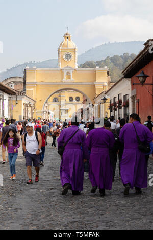 Antigua Guatemala UNESCO world heritage site - local people during holy week in the street, with Santa Catalina arch, Antigua Guatemala Latin America