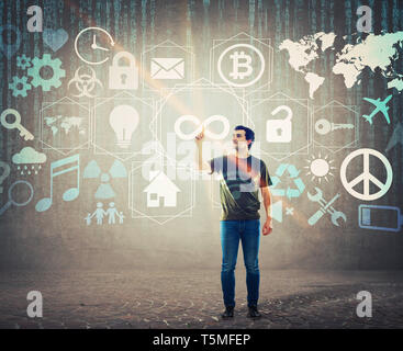 Casual young man pressing an infinity button on digital screen interface. Male forefinger touch a hologram display for limitless access features. Mode Stock Photo