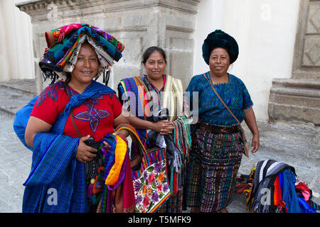 Guatemala lifestyle; Guatemala women selling scarves and textiles on the street, Antigua Guatemala Central America - example of Latin America culture