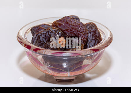 A group of madjool dates from Saudi Arabia on a white background for Ramadan. Stock Photo