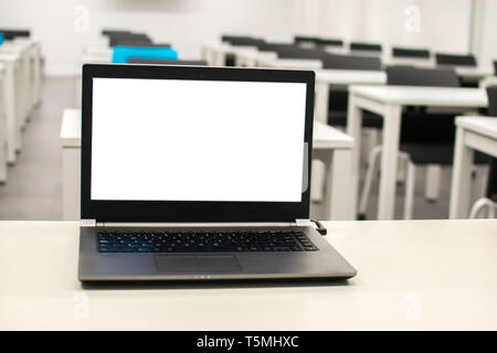 Laptop, online business, teacher work in the classroom.Laptop put on a table or desk located in empty room. Stock Photo