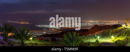 Al Ain View at Night from Jebal Hafeet (Jebel Hafit) showing the city lights from the top of the mountain. Stock Photo