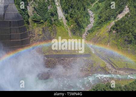 In Toyama, near the discharge of the huge power plant lake called Kurobedam, humidity creates a superb rainbow. Stock Photo