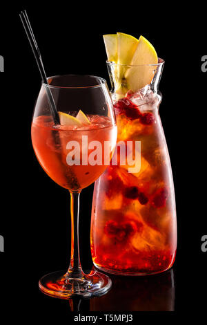 https://l450v.alamy.com/450v/t5mpj3/cold-sangria-in-pitcher-and-wine-glass-with-ice-cubes-isolated-on-black-background-t5mpj3.jpg