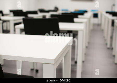 Classroom empty. High school or university desk or table and chairs in a row. Exam test room Stock Photo