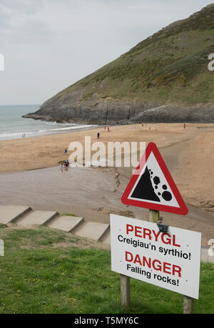Bilingual English/Welsh warning sign of falling rocks at Mwnt beach in Cardigan Bay, Ceredigion,Wales Stock Photo