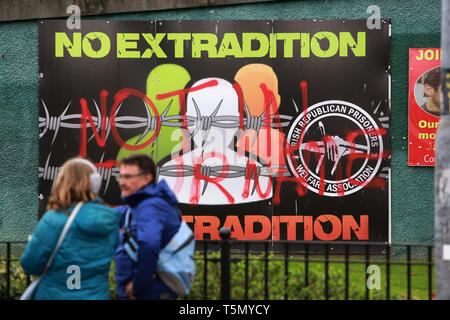 Derry, County Londonderry, Northern Ireland, 25th April, 2019 . Tourists look at defaced Dissident Republican posters in the Bogside area of Londonderry following the murder of Lyra McKee, a Journalists, 29, who was shot in the head on Thursday 18th of April, 2019. Ms McKee was observing rioting in Londonderry's Creggan estate. The New IRA later  admitted responsibility for the murder of journalist Lyra McKee.  Paul McErlane/Alamy Live News Stock Photo