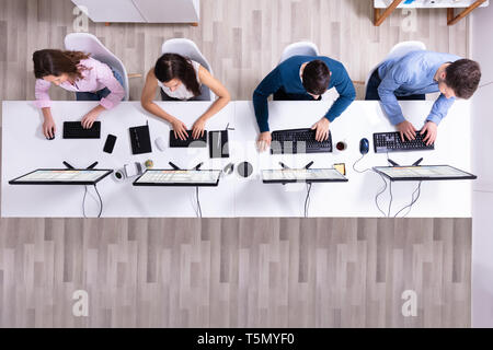 Young Businesspeople Analyzing Gantt Chart On Computer At Workplace Stock Photo