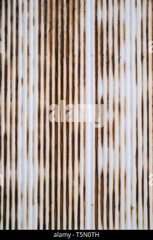 Old rusty wavy metal plate wall background Stock Photo
