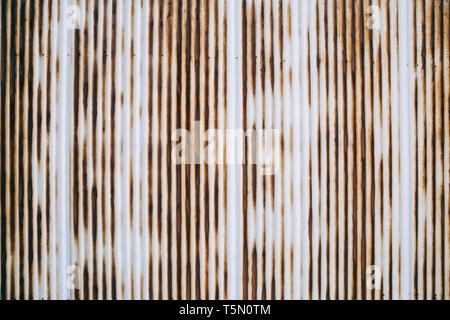 Old rusty wavy metal plate wall background Stock Photo