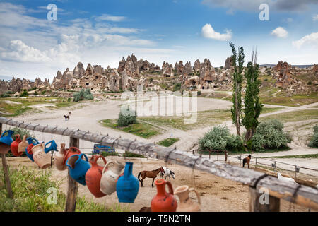 Horses near tufa geological formation with caves in Cappadocia, Turkey Stock Photo