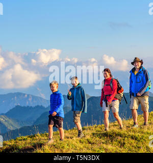 Active family hiking in high alpine region in austrian alps Stock Photo