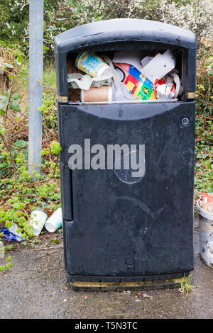 Lower Upnor, Kent, UK. A bin in the recycling area of a carpark is full with no more room to add more rubbish. Stock Photo