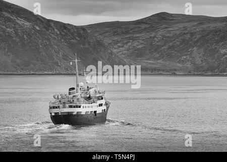 Black And White Photo Of The Historic Hurtigruten Ship, MS Lofoten, Steaming Northbound, High Above The Norwegian Arctic Circle, Norway. Stock Photo