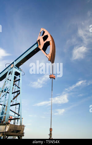 Oil and gas industry. Work of oil pump jack on a oil field. Blue sky Stock Photo