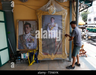 A worker seen arranging a portrait of Thailand's King Maha Vajiralongkorn Bodindradebayavarangkun (Rama X) for sale at a royal memorabilia shop, ahead of the royal coronation in Bangkok. Stock Photo