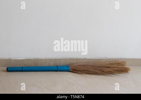 Broom lying on floor in the room Stock Photo