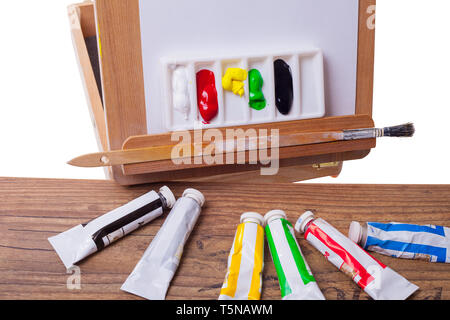 Acrylic paints on an easel - isolated on a white backgrond Stock Photo