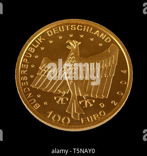 One hundret Euro gold coin from Germany - isolated on a black background Stock Photo