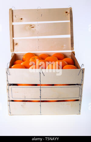 Oranges in large wooden box - isolated on a white background Stock Photo