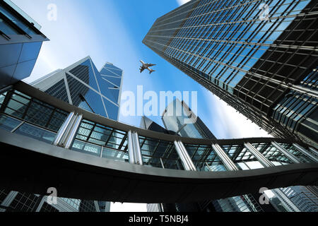 Modern business center in Hongkong. Skyscrapers in commercial area with airplane flying above at Hongkong. Asia Stock Photo