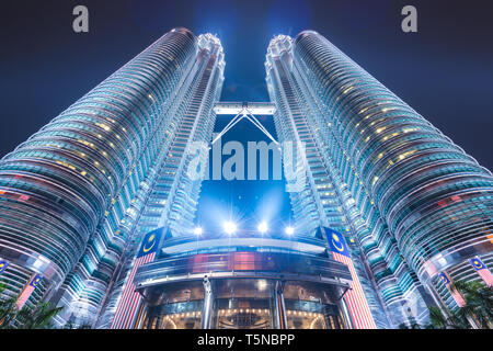 KUALA LUMPUR - SEPTEMBER 16, 2015: The Petronas Towers viewed from below at night. Stock Photo