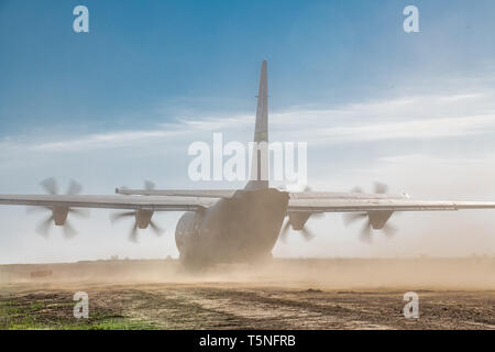 An Air Force C-130J Super Hercules assigned to 19th Airlift Wing, Little Rock Air Force Base, AR, touches down on a dirt runway at Fort Chaffee, AR during Operation Phantom Flight on April 12, 2019. Operation Phantom Flight is a joint service operation where both Soldier and Airmen worked alongside one another to successfully mobilize and transport Steel Warrior Battalions HIMARS from Henry Post Army Airfield, OK, to Fort Chaffee, AR, in order to successfully conduct an air/land raid. (U.S. Army photo by Sgt. Dustin D. Biven / 75th Field Artillery Brigade) Stock Photo