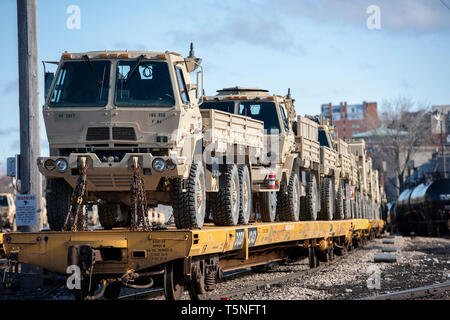 U.S. Army tactical vehicles assigned to the 86th Infantry Brigade Combat Team (Mountain), awaits transport after being loaded onto rail cars in Burlington, Vt., April 16, 2019. Soldiers from Vermont, Massachusetts and Connecticut loaded and over 600 vehicles onto 210 rail cars to be transported to Fort Polk, Louisiana in preparation for a Joint Readiness Training Center rotation next month. (U.S. Air National Guard photo by Master Sgt. Sarah Mattison) Stock Photo