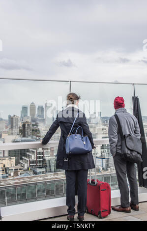 Visitors to the Fen court enjoying the views towards the Canary wharf Stock Photo