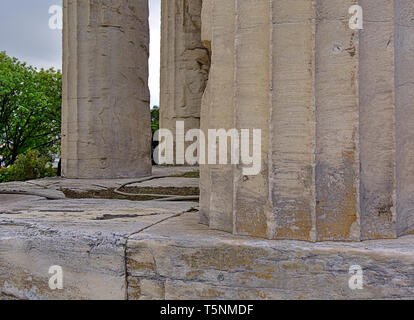 Temple of Hephaestus in Athens, Greece. Close up to columns. Tree and cloudy sky in the background. Stock Photo
