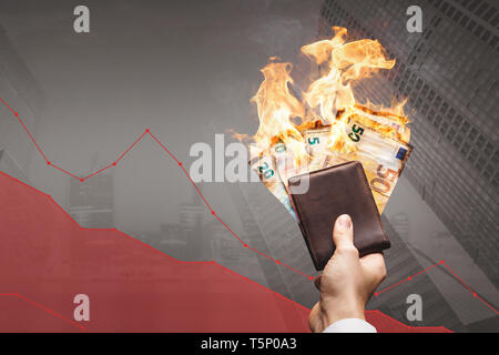 Loosing money concept – burning Euro bills in front of a declining graph