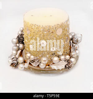Silver candle with glittering ornaments on glass tray Stock Photo