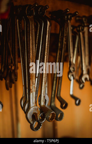 different organized metal spanner tools in a garage, close up Stock Photo