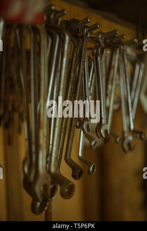 different organized metal spanner tools in a garage, close up Stock Photo