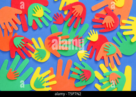 Funky foam hands of different sizes in red, orange, yellow, green and blue on a plain background Stock Photo