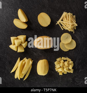Different cuts of potatoes on a black textured background. Photo taken from above Stock Photo