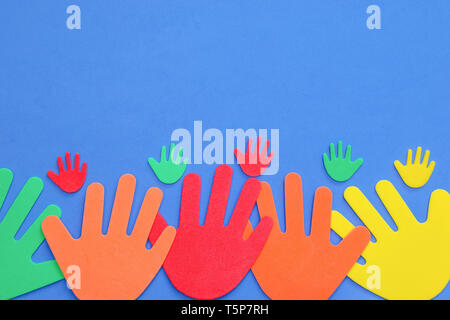 Funky foam hands of different sizes in red, orange, yellow, green and blue on a plain background Stock Photo