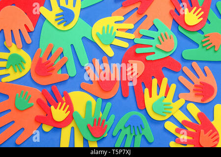 Funky foam hands of different sizes in red, orange, yellow, green and blue on a plain background Stock Photo