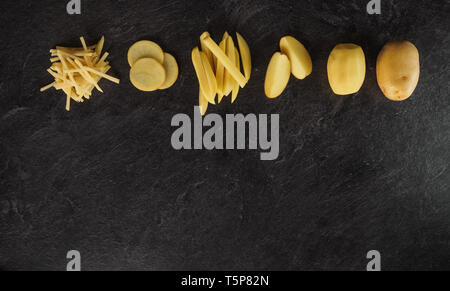 Different cuts of potatoes on a black textured background. Photo taken from above Stock Photo