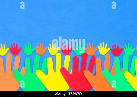 Funky foam hands of different sizes in red, orange, yellow, green and blue on a plain background Stock Photo