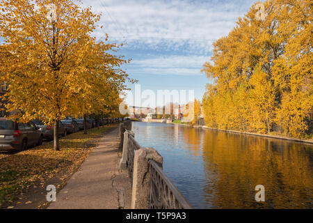 Sunny autumn day in St. Petersburg. Linden trees with yellowed leaves on the Moika River Embankment Stock Photo
