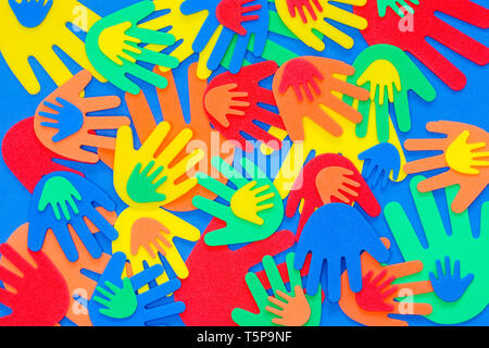 Funky foam hands of different sizes in red, orange, yellow, green and blue on a plain background Stock Photo