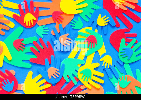 Funky foam hands of different sizes in red, orange, yellow, green and blue on a plain background Stock Photo