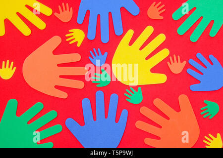 Funky foam hands of different sizes in red, orange, yellow, green and blue on a plain background Stock Photo