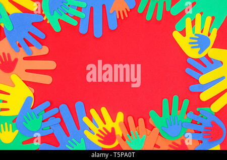 Funky foam hands of different sizes in red, orange, yellow, green and blue on a plain background Stock Photo