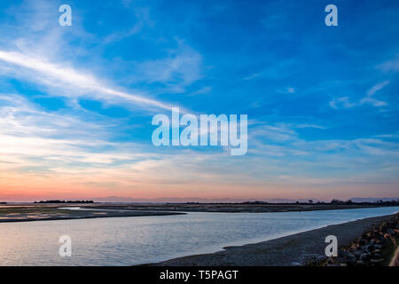 Sun goes down on the lagoon of Grado in a spring day Stock Photo