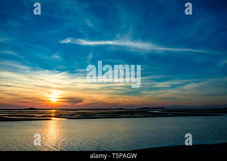 Sun goes down on the lagoon of Grado in a spring day Stock Photo