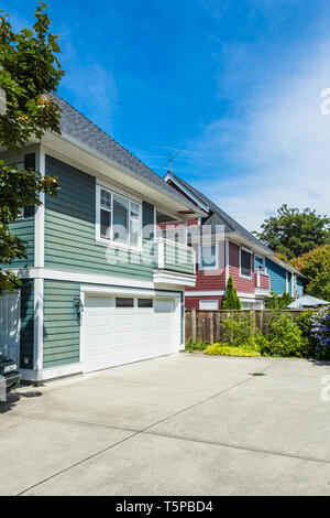 Garage entrance of residential family house with concrete driveway in front. Stock Photo